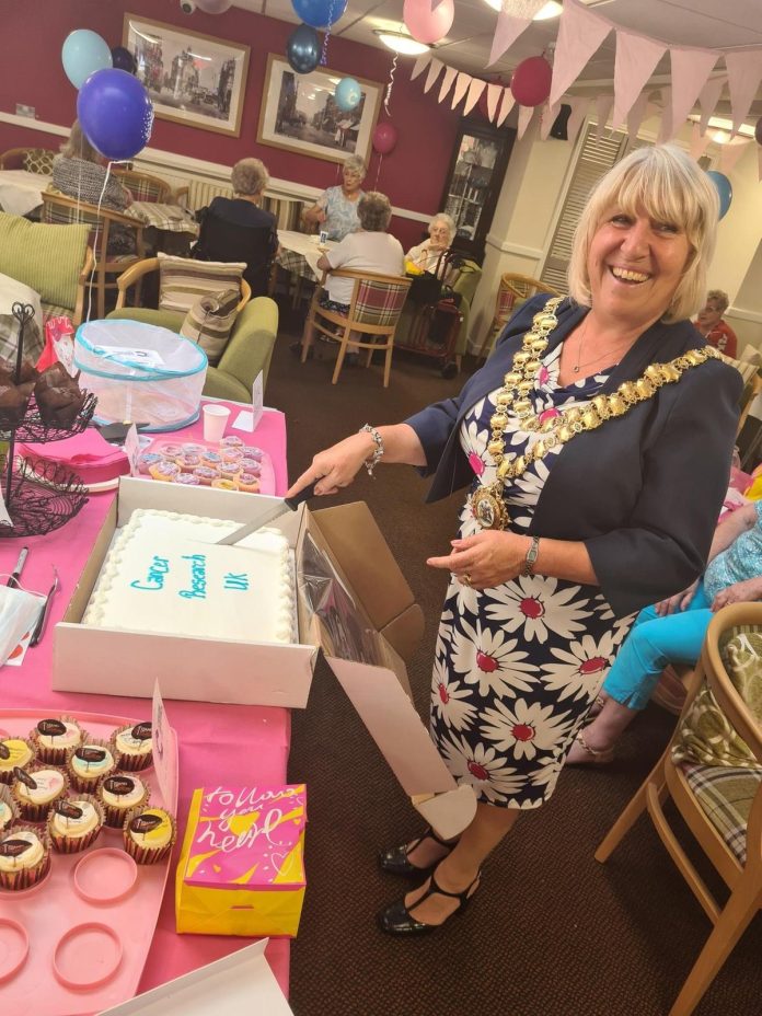 Cash rolls in for Cancer Research UK as Wigan care home holds fun day

